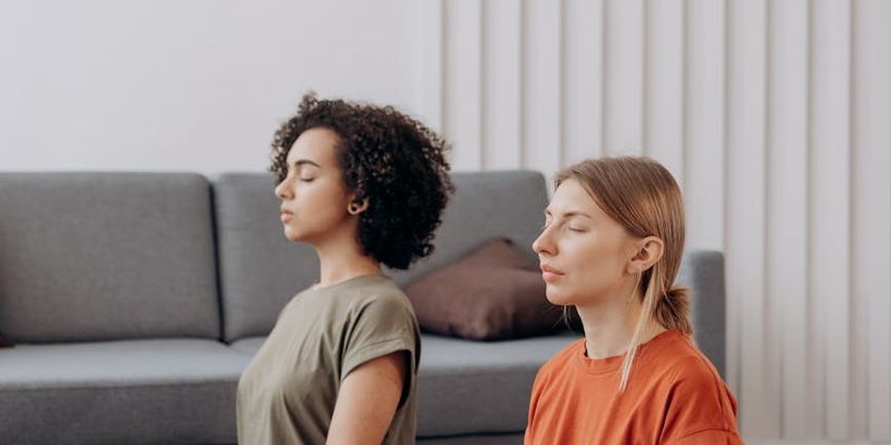 Person holding a balanced yoga pose in a minimalist room.
